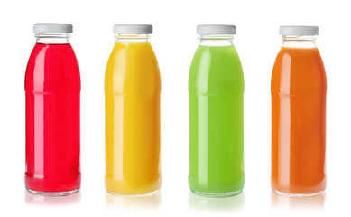 Set with glass bottles of different juices on white background