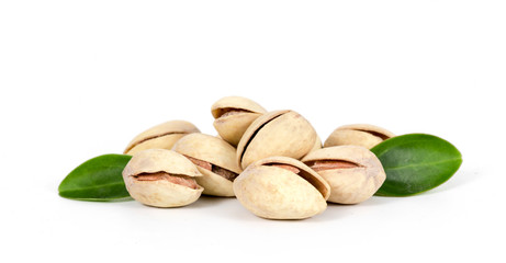 Pistachios with leaves isolated on white background