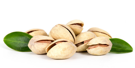 Pistachios with leaves isolated on white background