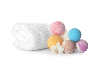 Bath bombs and towel on white background