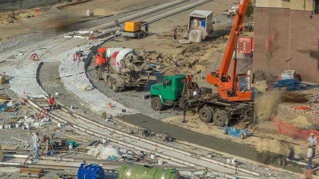 Concrete works for road construction with many workers and mixer timelapse