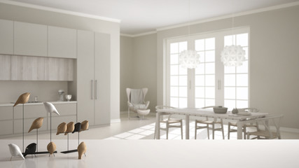 White table top or shelf with minimalistic bird ornament, birdie knick - knack over classic kitchen with wooden and beige details, dining table laid for two, modern interior design