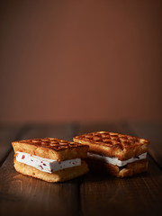 Juicy Viennese waffles on a dark wooden background.