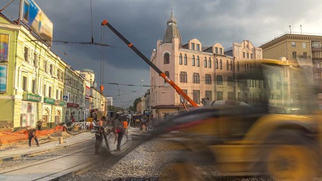 Concrete works for road construction with many workers and mixer timelapse
