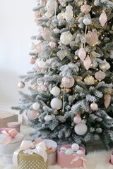 new year and Christmas tree with white and pink toys under the snow