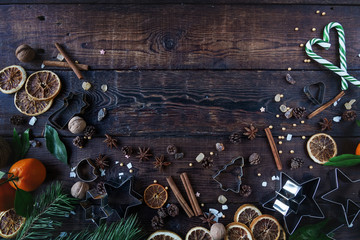 Christmas or New Year decoration,  tangerine, candy cane, dry oranges, sugar, wallnuts and cookie cutters in star shape