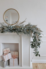 fireplace with gifts decorated for Christmas in luxury apartments with white walls