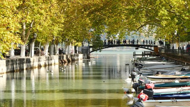View on the canal du vassé in Annecy, France. It is "Pont des amours" (the love bridge), a particularly famous, touristic place in the city. Filmed in October, in autumn.