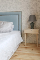 soft blue bed and lamp on the bedside table in luxury apartments
