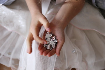 silver confetti stars in the girl's hand