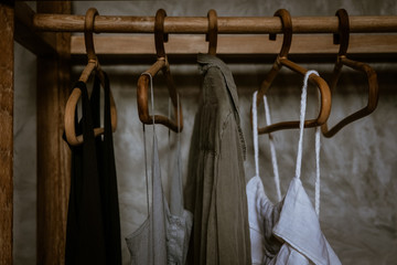Boho chic open wardrobe, clothing rack, rattan wooden hangers, Fashion blogging concept, neutral...