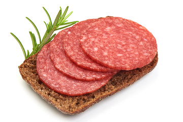 Smoked Meat Sausages with rosemary on a rye bread, isolated on a white background. Close-up