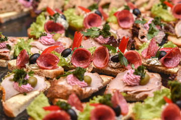 A lot of sandwiches on the epergne, sandwich buffet.