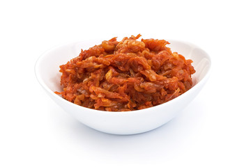 Stewed carrots in bowl, isolated on a white background. Close-up.