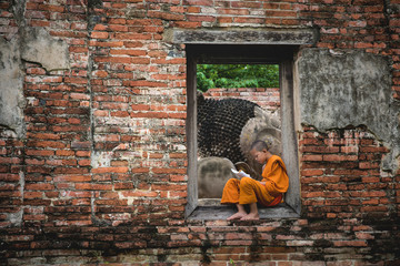 Thailand novice monk reading a book. Novice monk learning in temple, Ayutthaya province, Thailand