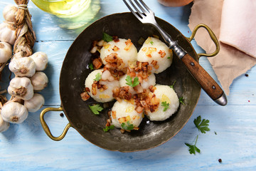 Meat stuffed potato dumplings with fried onion  and greaves on top