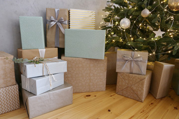 Gift boxes under the Christmas tree at the luxury apartment