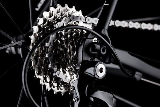 bicycle bike rear derailleur gear casette chain detail close up shot black dark background 