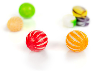 Fototapeta na wymiar Sweet candies of different color lie on a white background