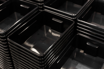 black plastic containers stack in a store