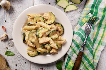 Penne pasta witch chicken and zucchini in cheese sauce