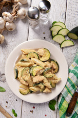 Penne pasta witch chicken and zucchini in cheese sauce