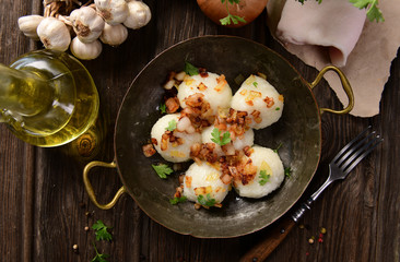 Meat stuffed potato dumplings with fried onion  and greaves on top