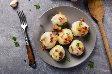Fototapeta na wymiar Meat stuffed potato dumplings with fried onion and greaves on top