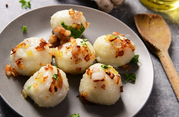Meat stuffed potato dumplings with fried onion  and greaves on top