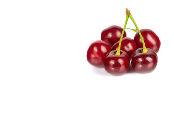 Ripe cherries lie on a white background