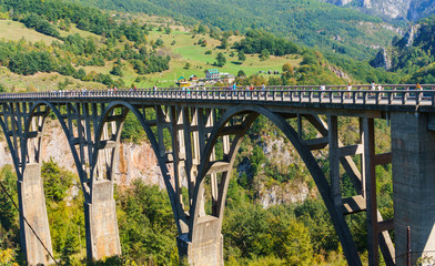 Fototapeta na wymiar Concrete arch bridge Durdevitsa-Tara across the Tara river canyon in Montenegro. September 2018