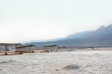 Fototapeta na wymiar The dried-up bottom of the shallowed Dead sea