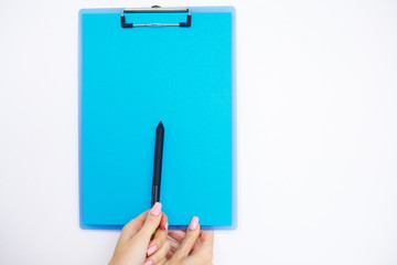 Blank Folder with Blue Paper. Hand that Holding Folder and Pen on White Background. Copyspace. Place for Text