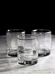 Empty old fashion glass on black background