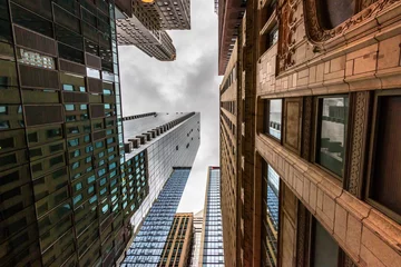 Foto op Aluminium Wide-angle view looking up through tall buildings and skyscrapers in downtown Chicago Illinois © SIX60SIX