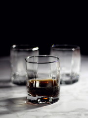 Old fashion glass of whiskey and cola on a dark background