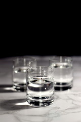 Relaxing crystal glass shot of vodka on a dark background