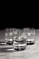 Relaxing crystal glass shot of vodka on a dark background