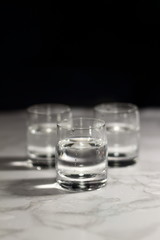 Relaxing crystal glass shot of vodka on a dark background