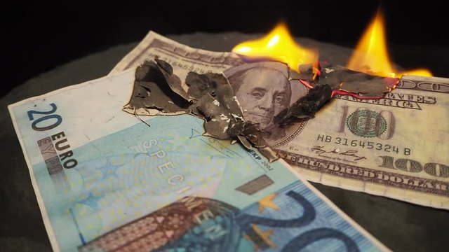 twenty euros - 20 and euro-coins burn in a fire on a black background. Close up of european currency is on fire. Concept of stock market crash and currency depreciation. 4k. Conceptual finance image D
