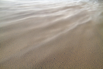 Fototapeta na wymiar Storm blowing sand over the beach