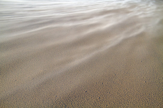 Storm Blowing Sand Over The Beach