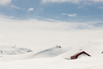 Wooden cottage under snow - Norway.