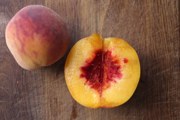 organic fruit, half of peach on the wooden table
