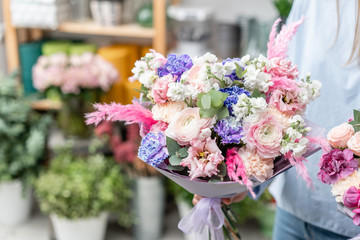 European floral shop. Two Bouquet of beautiful Mixed flowers in woman hand. Excellent garden flowers in the arrangement , the work of a professional florist.