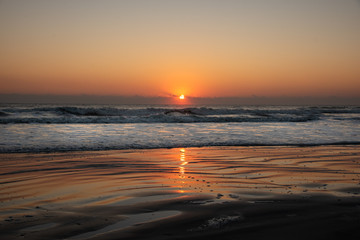 Fototapeta na wymiar Beach shot with waves during sunrise in Saint Augustine Beach