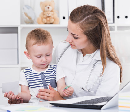 Doctor is examining young client