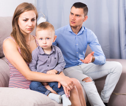 Sad male and female with child thinking about quarrel