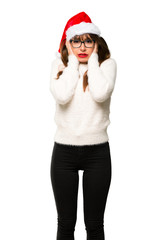 Girl with celebrating the christmas holidays covering ears with hands. Frustrated expression on isolated white background