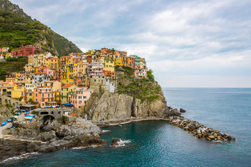 Fototapeta na wymiar beach streets and colorful houses on the hill in Manarola in Cinque Terre in Italy 